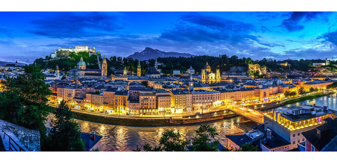 A stunning view of the illuminated old town of Salzburg at dusk. In the background, the Hohensalzburg Fortress is visible. | © TSG_Breitegger