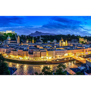 A stunning view of the illuminated old town of Salzburg at dusk. In the background, the Hohensalzburg Fortress is visible. | © TSG_Breitegger